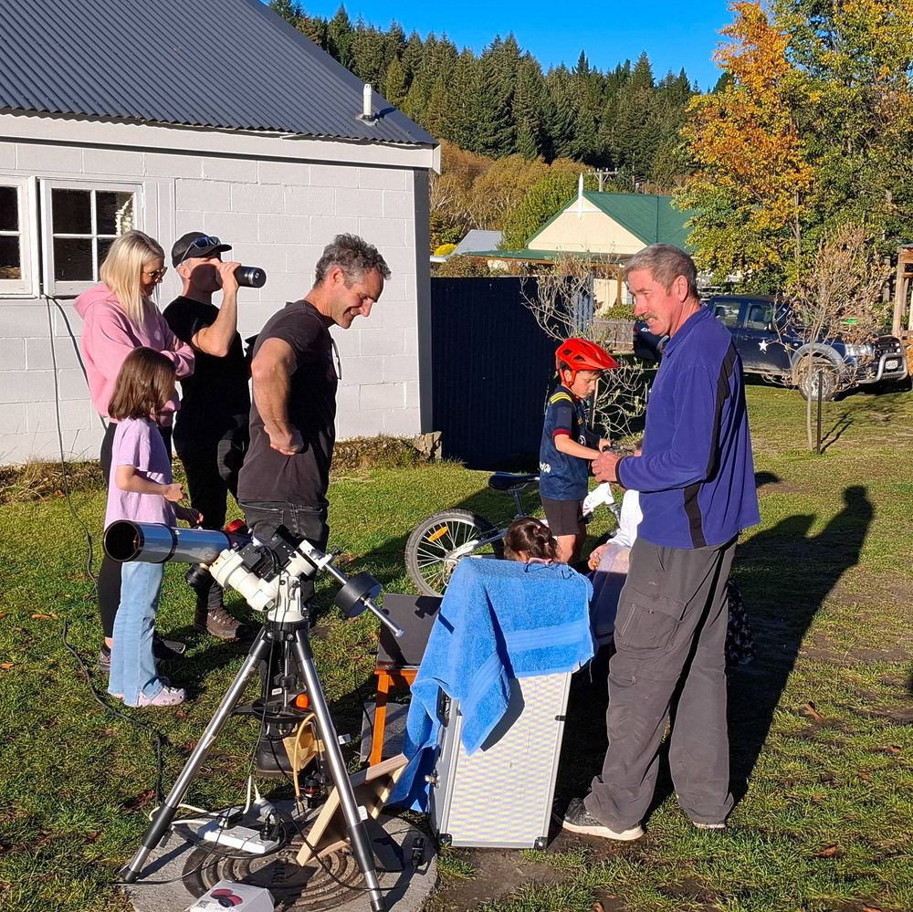 People gathering around a solar telescope in Naseby.
