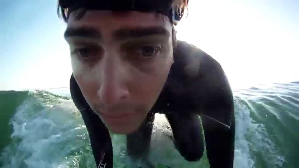 A still of a facecam video of somebody surfing 