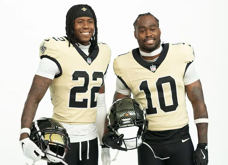 A picture showing one of the new uniforms the New Orleans Saints (whose team colors are black and gold) introduced for the 2025 season, where the jersey is not gold so much as it is tan or urine colored