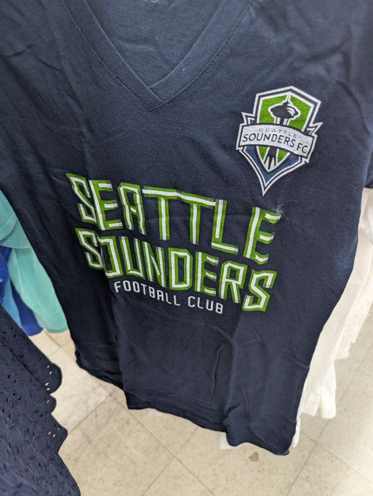 A shirt that reads "Seattle sounders football club"