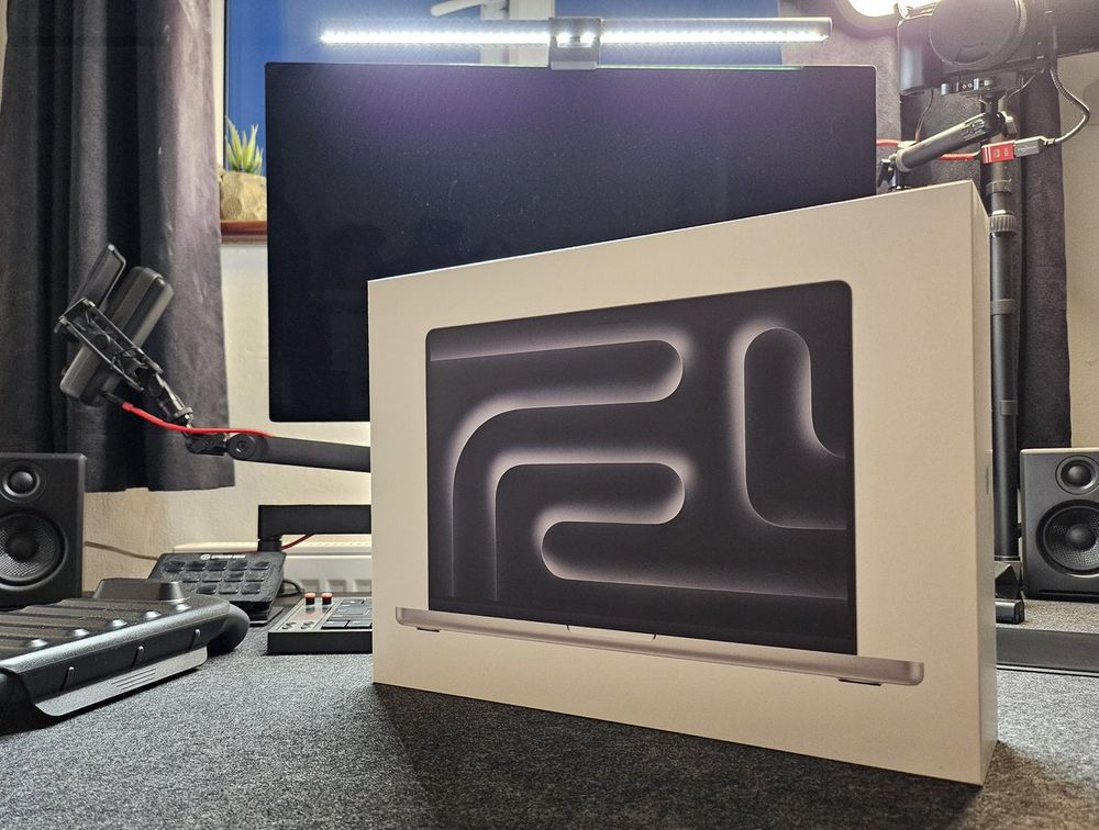 New Macbook Pro box sitting on Jhey's desk