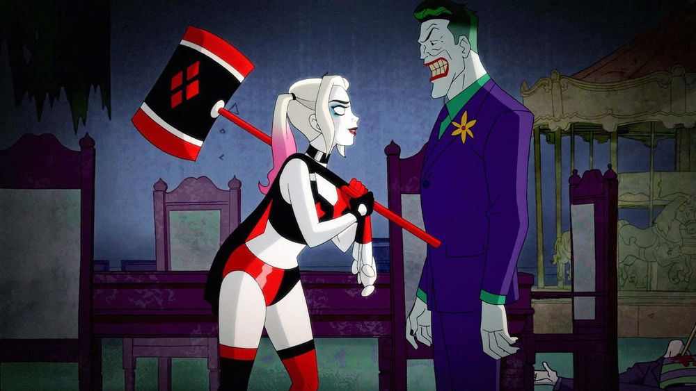 Harley Quinn holding a big whack-a-mole style hammer looking at Joker like he’s a mole