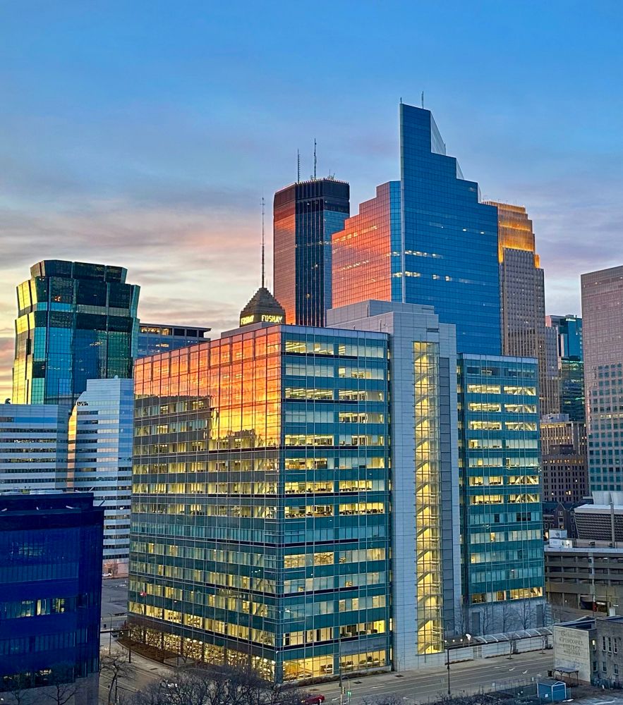 Sun set reflecting orange, red and yellow on the Mpls downtown buildings (IDS, Foshay, and Ameriprise).