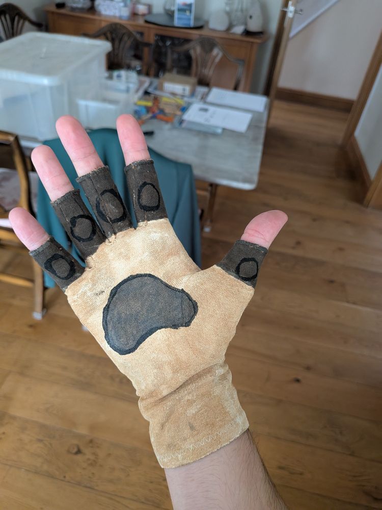 cream fingerless compression gloves with paw pads painted on and grey brown fingers