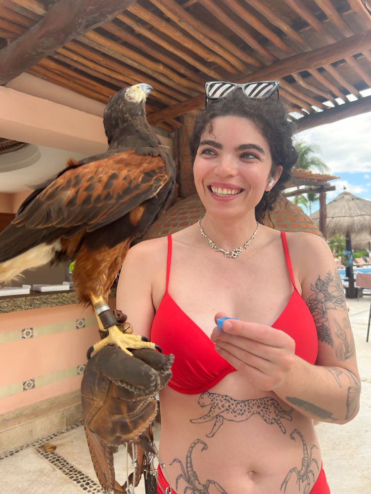Me holding a Harris hawk in a bikini