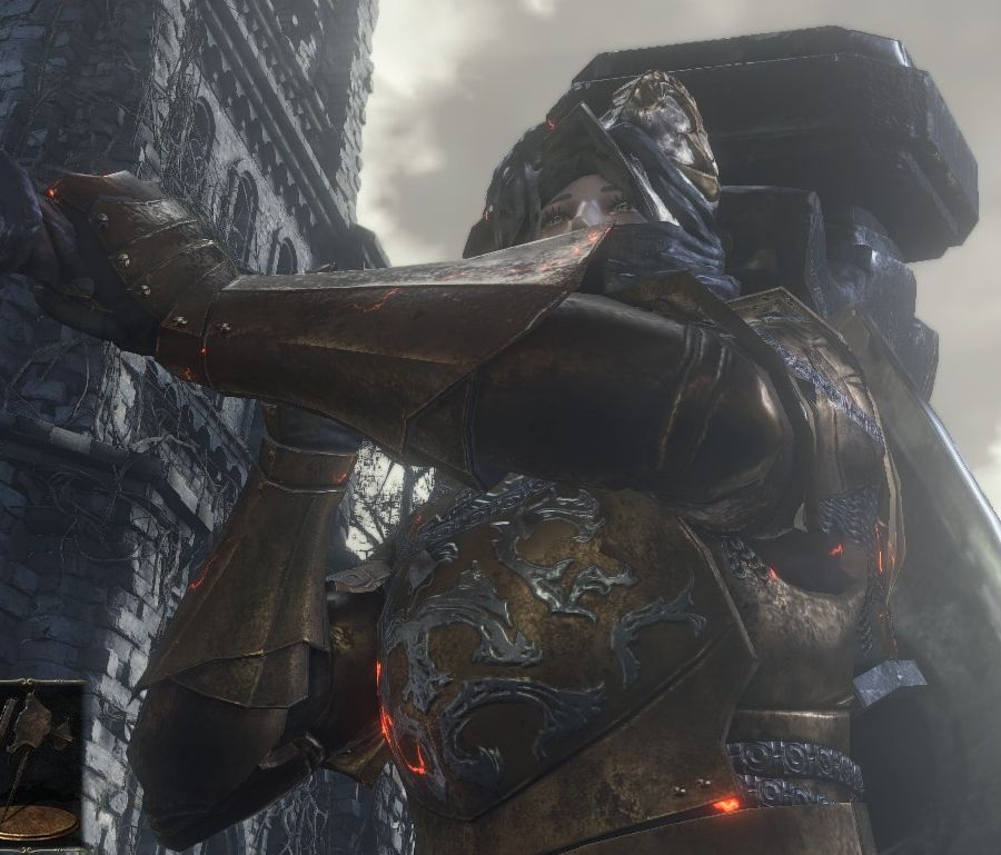 Cropped Dark Souls 3 screenshot looking up at Marzipan the Third from below, all tattooed eye (gold streaks) and big lashes. She's wearing the brass set, Hodrick's helm, and carrying the massive Ledo's Hammer.