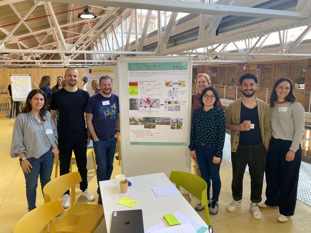A group of people standing next to a poster
