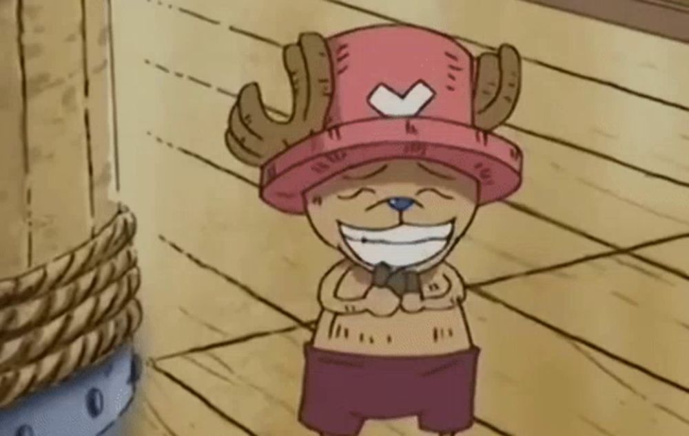 a cartoon character wearing a pink hat with horns is smiling on a wooden floor