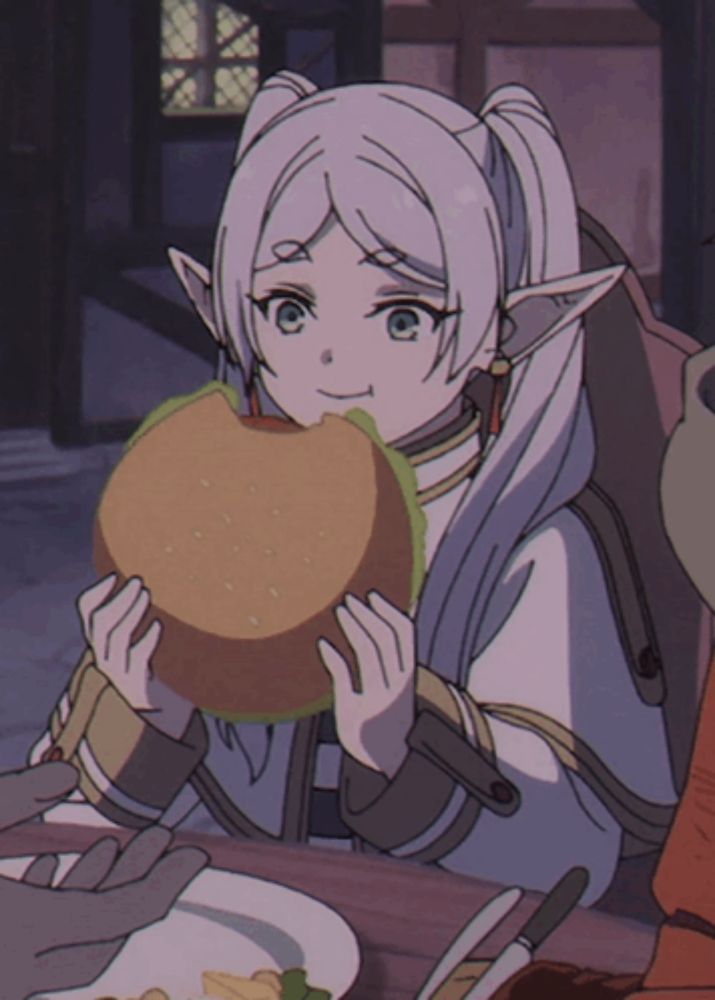 a girl with white hair and ears is holding a hamburger in her hands