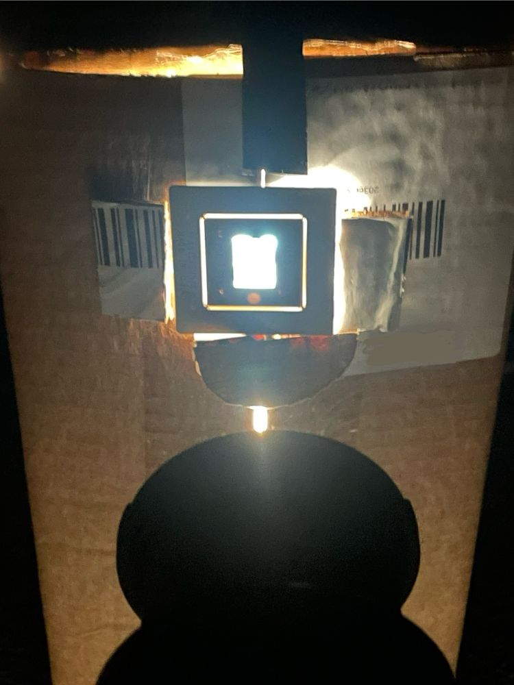 The same square hole with a slide being lit from the back