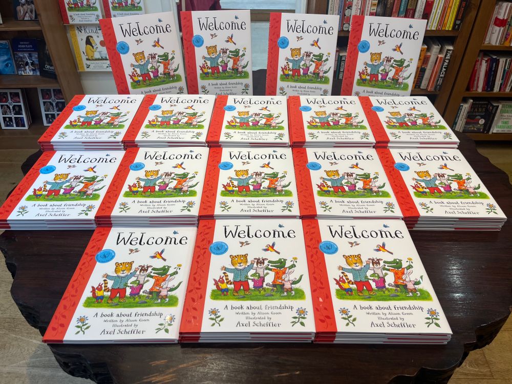 The Welcome Book launch- many copies on a table 