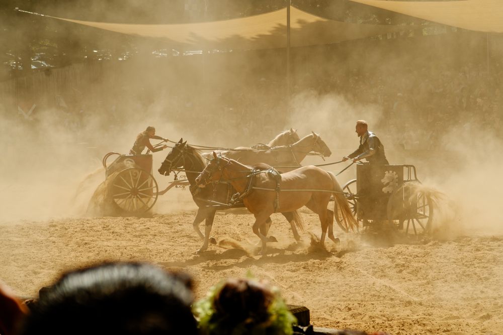Maryland Renaissance Faire, in the arena, two chariots circling each other in a wall of dust
