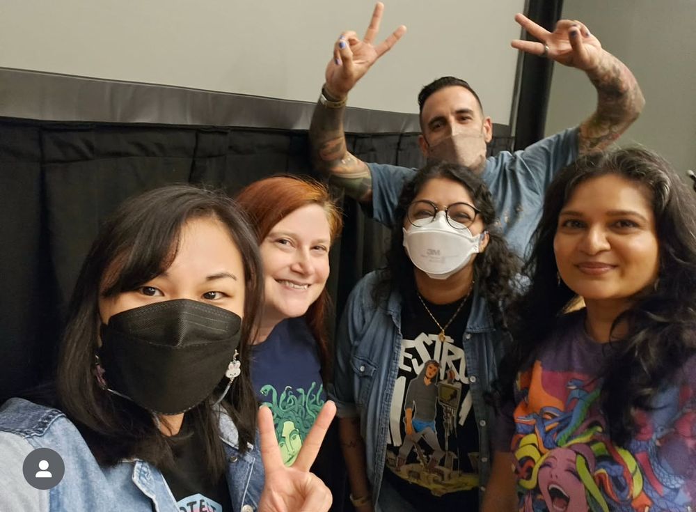 A picture of me, Kat Cho, Mark Oshiro, Sajni Patel, and Elara Dunn smiling after a panel. Mark, Kat, and I are all wearing masks. 