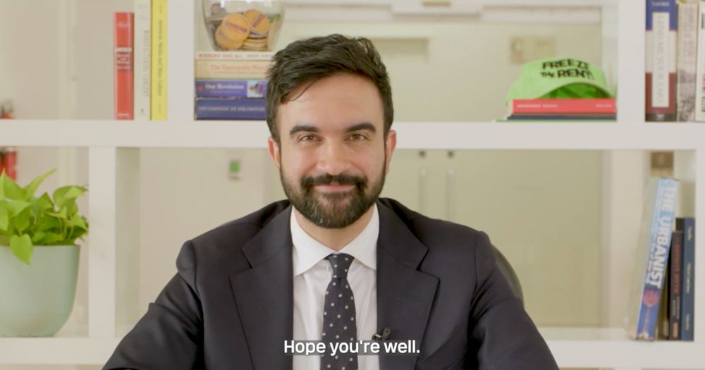 Zohran Mamdani looking at the camera with a smirk and saying, "Hope you're well." 