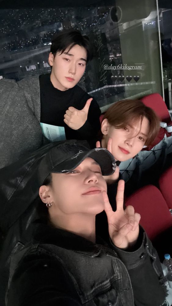 kpop group ateez members jung wooyoung front, kang yeosang middle, choi san back posing for a selfie together