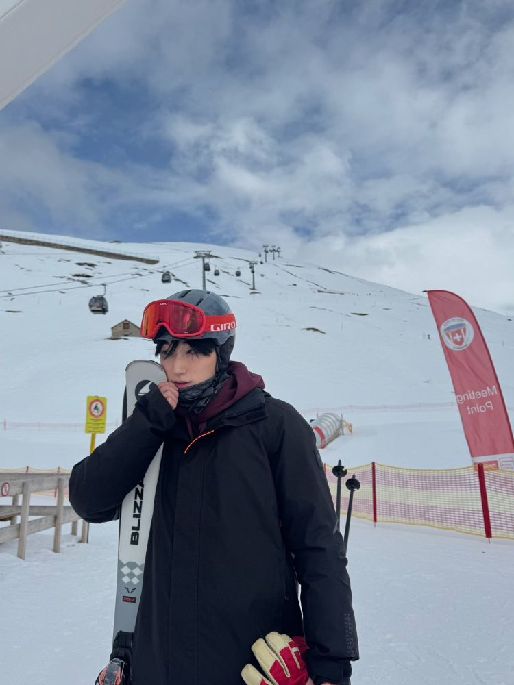 kpop group ateez member choi san photographed in snowboarding gear at a ski resort