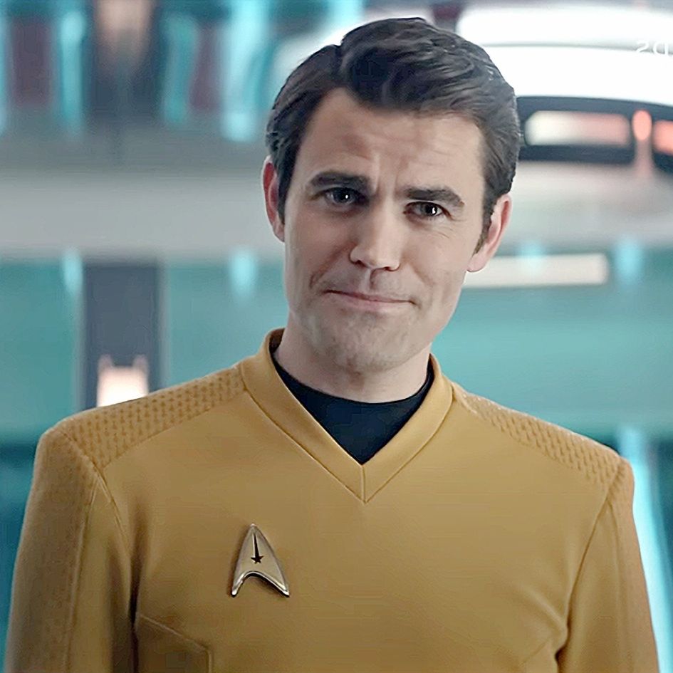 Evil mirror (because this image is flipped horizontally compared to the left image. Aka Mirrored.) Captain Kirk from Star Trek: Strange New Worlds with a smirk on his face.