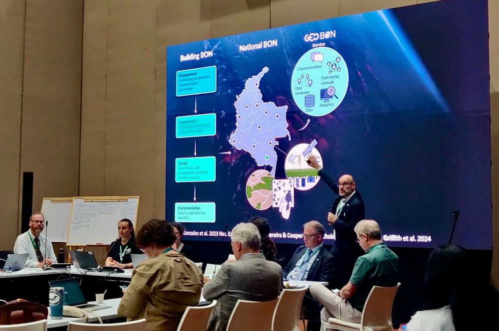 Giving a talk in front of a giant screen at COP16 about how to transform our ability to monitor biodiversity and understand change so that we can act rapidly and effectively. 