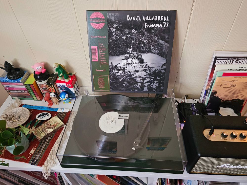 Daniel Villareal "Panama 77" spinning on a turntable next to various figurines. Godzilla, things of that nature. #nowspinning #vinylsky #jazzsky