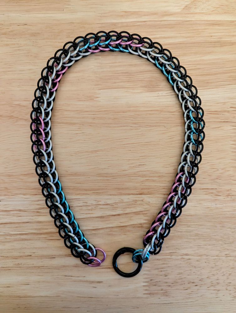 My new custom made collar featuring matte black, matte silver, shiny pink, and shiny sky blue chainmail rings