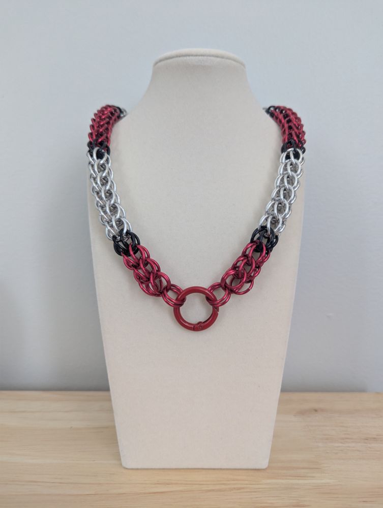 Chainmail collar using the shiny black, red, and silver in the design of the Umbrella Corp logo from Resident Evil