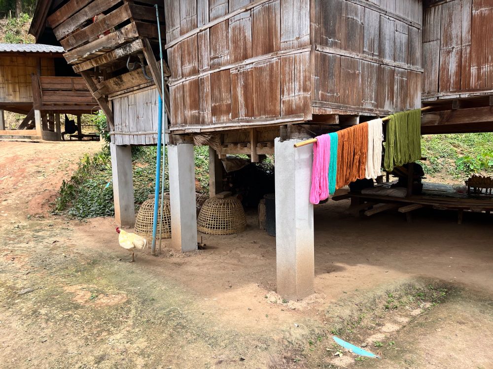 A detail from a traditional Thai home with dyed yarn drying