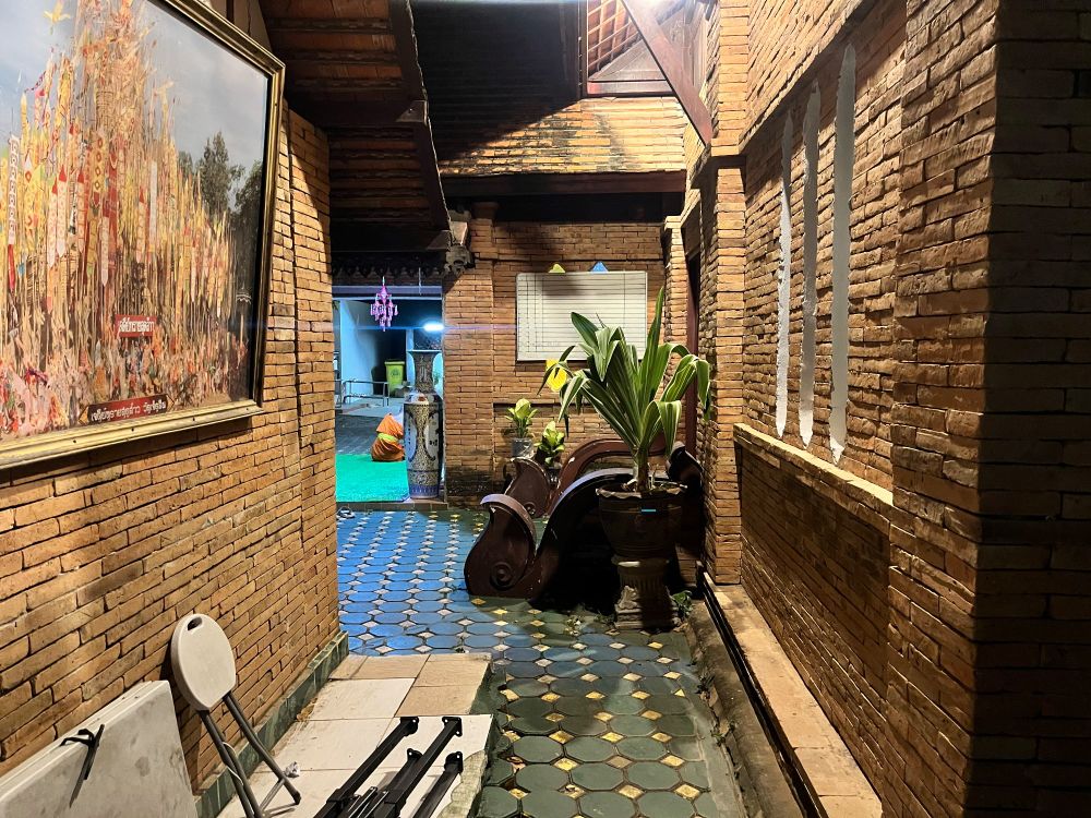 A brick lined alley behind a temple