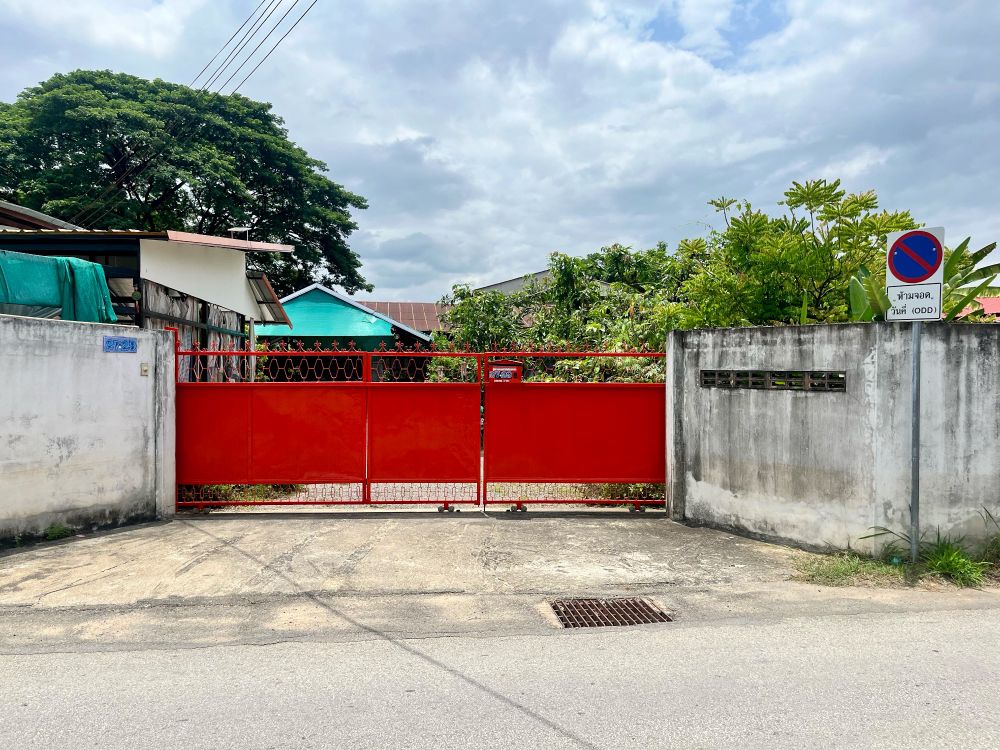 A long red driveway gate