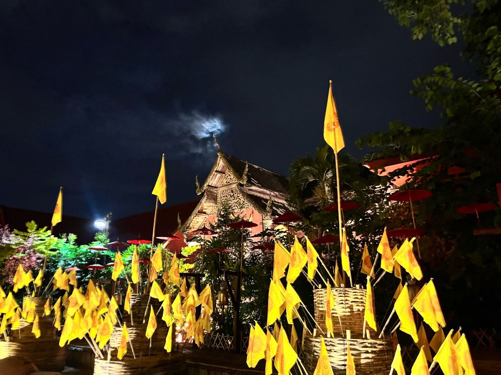 Flags in front of a temple at night