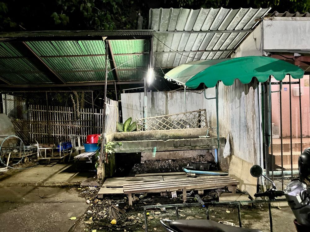 A jumbled pile of unidentified objects behind a street market