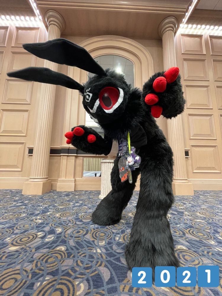 Moff fursuit 
All black moth fursuit with white accent markings under the eyes and on the forehead. It has red claws and eyes