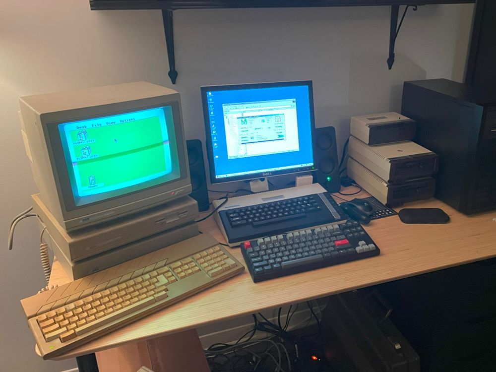 An Atari Mega ST next to a Atari 800XL with accessories and other computer keyboard and case