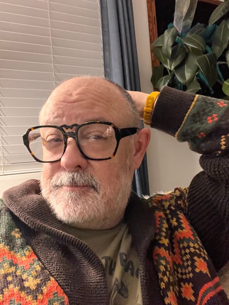 Very tired Roger wearing a heavy sweater, about to yawn 