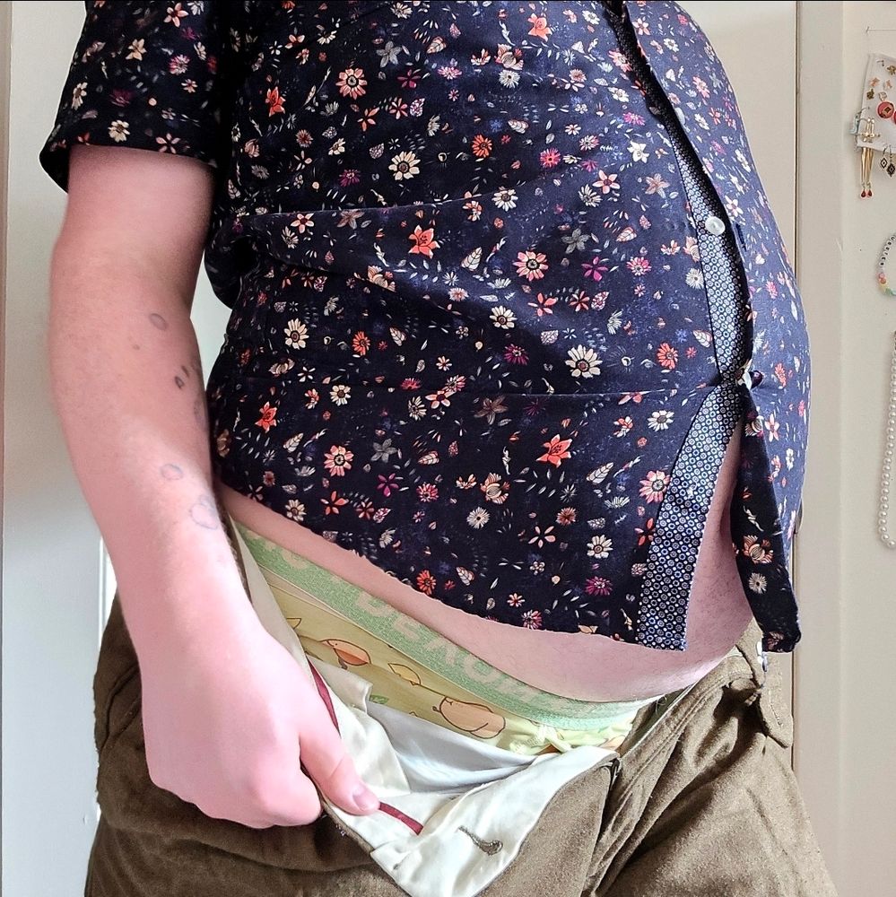 Standing to the side, im wearing a too small shirt and the buttons are straining, I've opened and unzipped my pants.