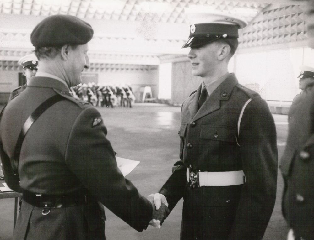 Gary, in Royal Marines uniform at RM Depot Deal, is shaking hands with Major General Whiteley (who later became General and Commander-in-Chief of Allied Forces Northern Europe). The photo was taken in the Drill Shed at the Royal Marines base in Deal, Kent, which no longer exists. At that time, the first stage of Royal Marines training started at Deal before trainees were transferred to the Royal Marines Commando Training Centre at Lympstone.