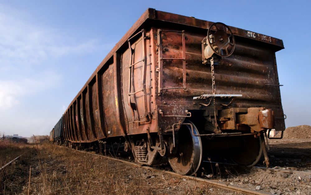 A rusty the rail car set against a blue sky.
