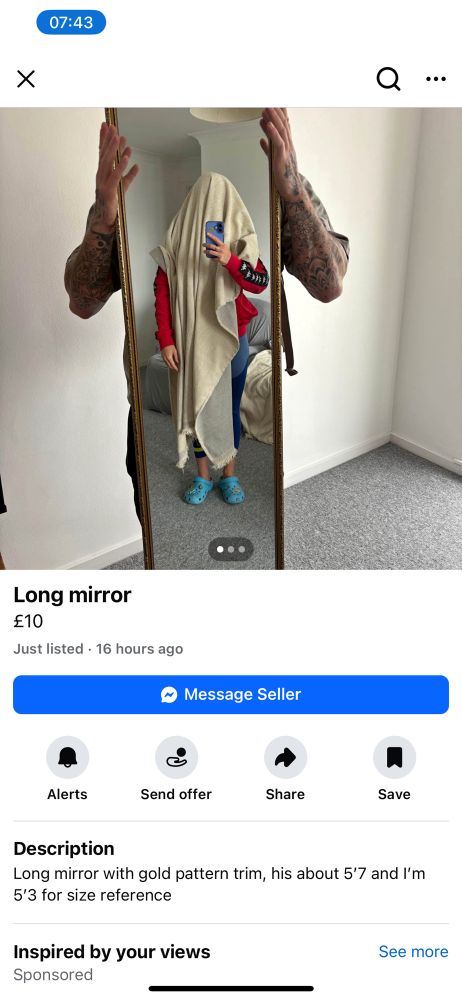 A Facebook marketplace listing for a long mirror. The mirror is being held from behind by one person and the picture taken by someone who is shown reflected, but covered in a blanket or sheet like the classic comic depiction of a ghost. 