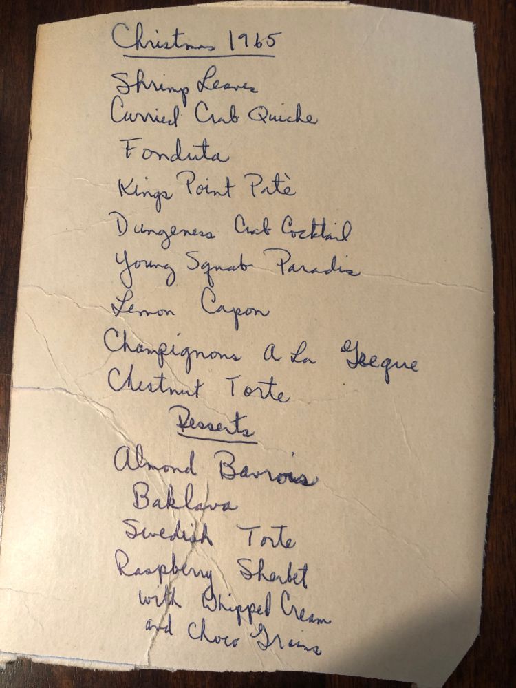 A handwritten list of 9 dishes for the Christmas meal, including Curried Crab Quiche and Lemon Capon and Champignons a la Grecque, and four desserts that included Almond Bavarois, Swedish Torte, and Baklava