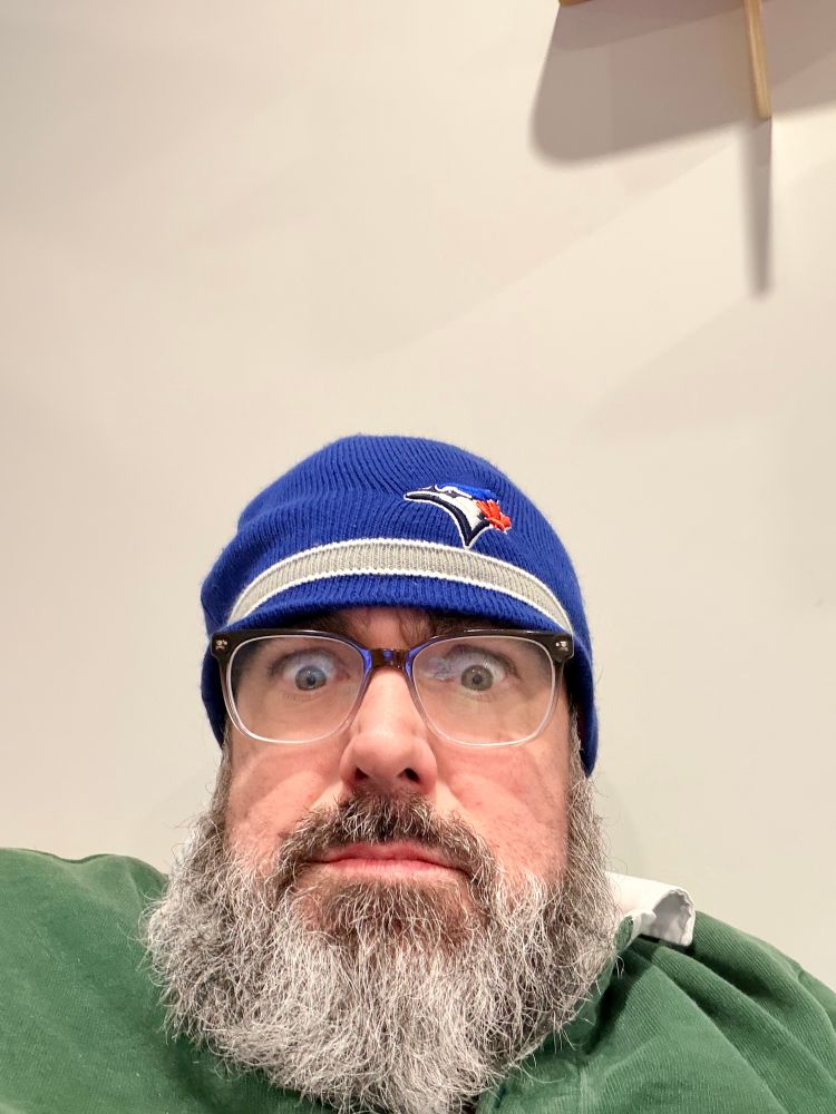 Me a white dude with a grey beard and a Blue Jays toque looking very stressed