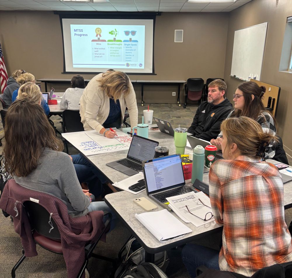 ESU 5 educators sit at tables during presentations.