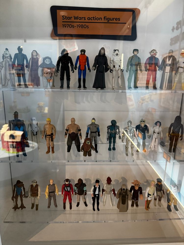 Museum display case of 1970s and 1980s Star Wars action figures. 