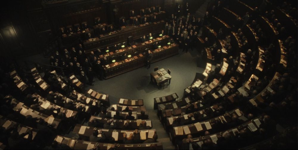 bird's eye view of the italian parliament with mussolini in the center as he asks if anyone will move against him. no one did.
