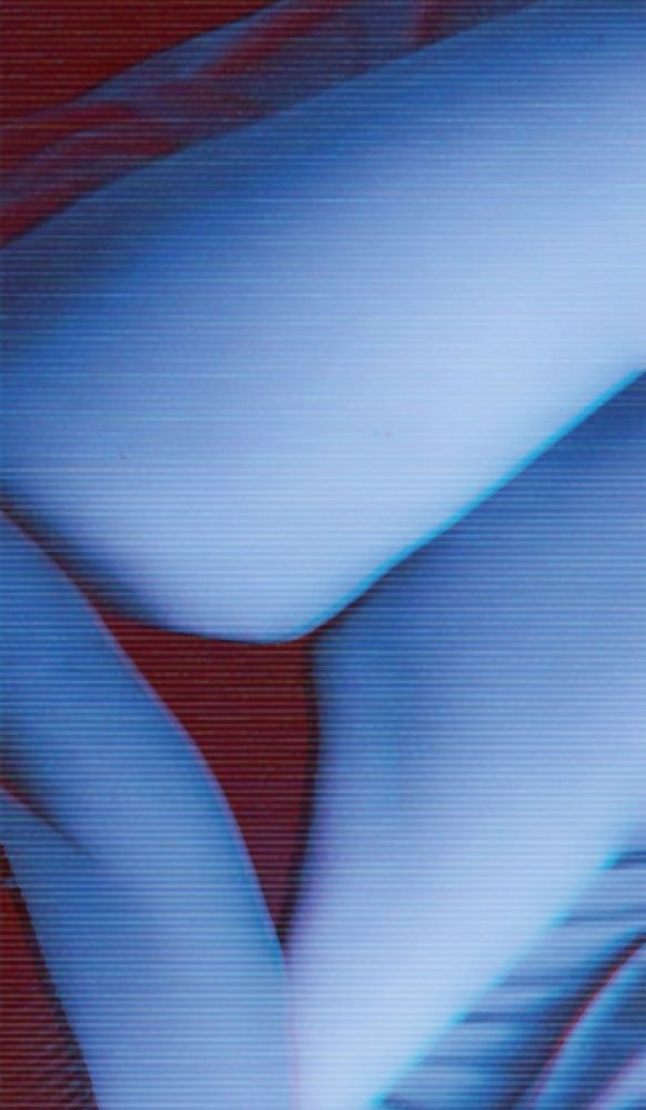 Photo of Darling, focusing on the lower half of their body. Their belly is visible, their underwear showing and their legs squish together at their thighs. There's an old film filter on the whole photo, giving it a blue/red tint.