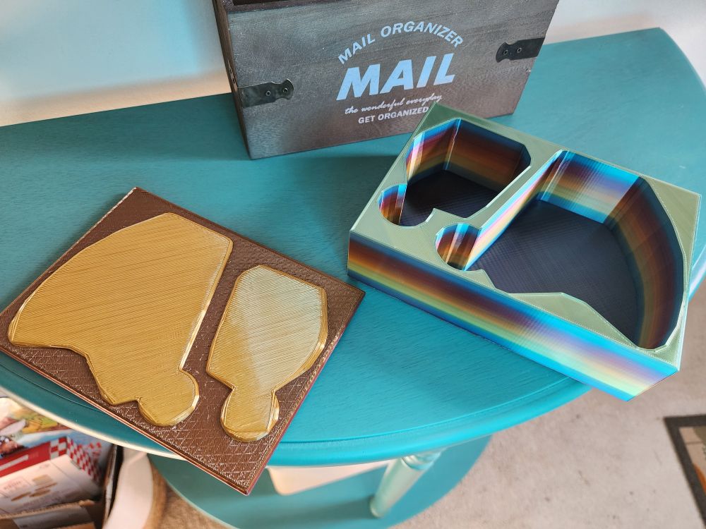 The box and lid next to each other. The lid has embossed shapes that exactly fit the holes so the lid will not move around when it's on top. 