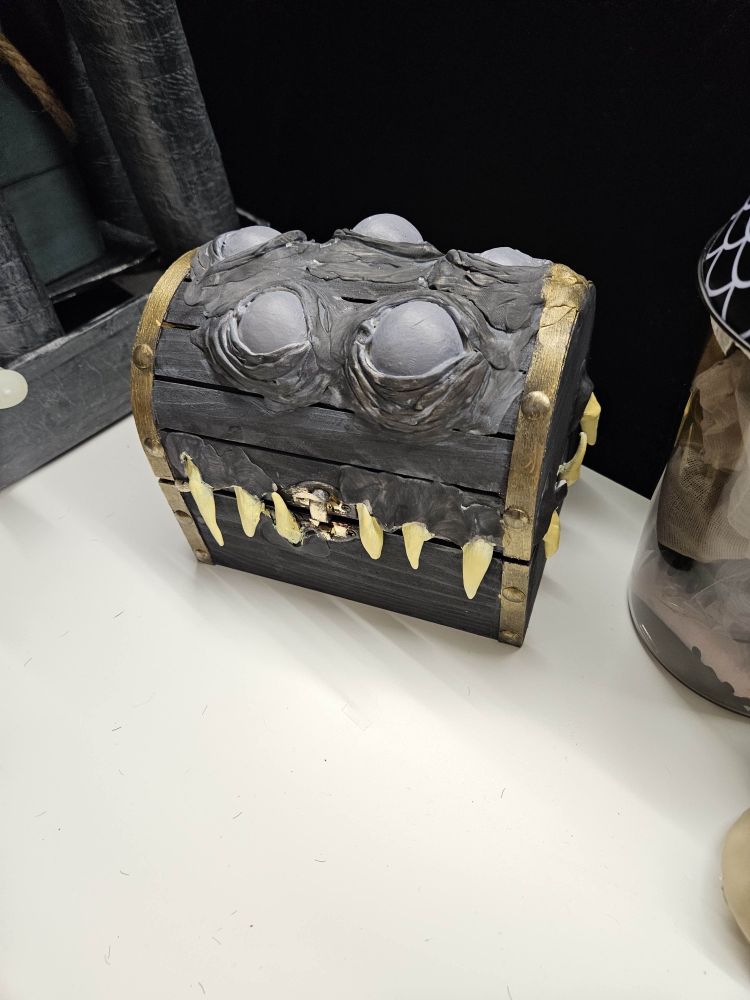 An older mimic chest looking respectfully with all 5 of his eyes