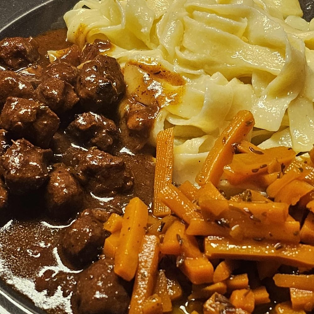 Meatballs made from Bratwurst meat and glazed caraway carrots from leftovers; served with Fettuccine