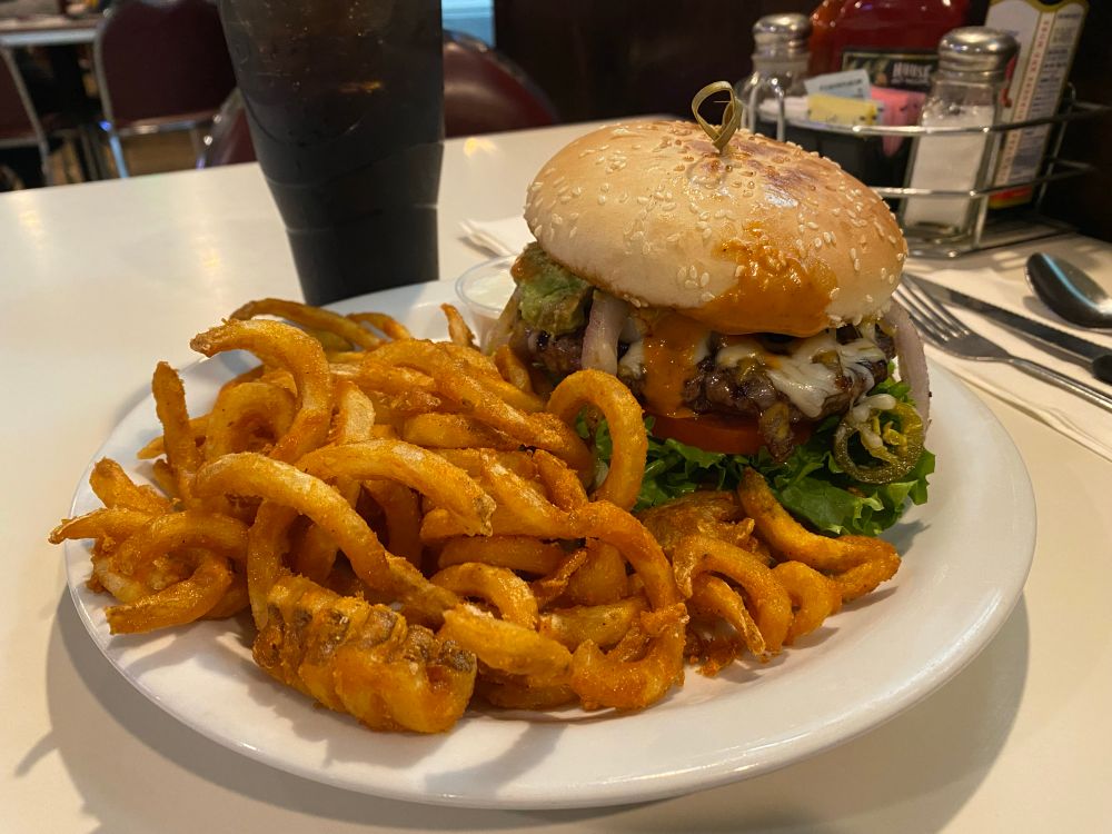 Spicy guacamole burger with curly fries