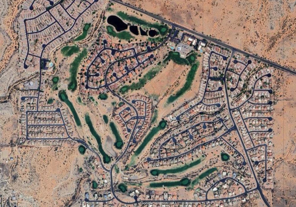 nearby desert housing development with intensely struggling golfing greens