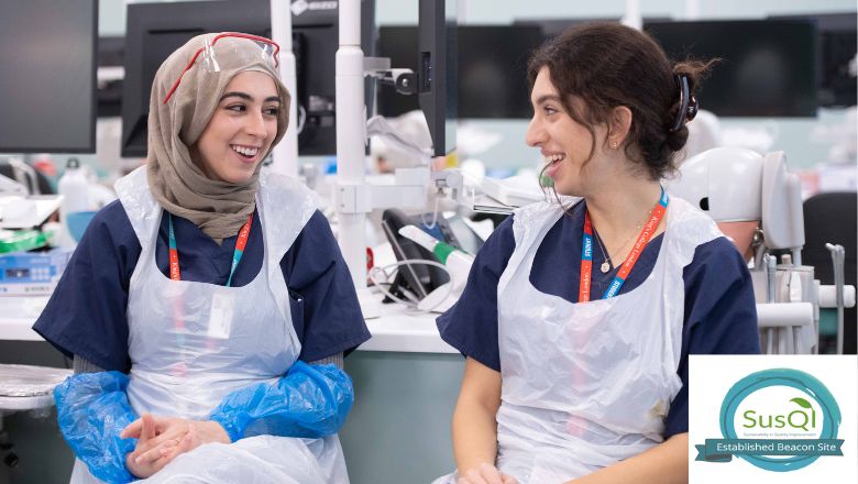 Two people in PPE in a lab setting