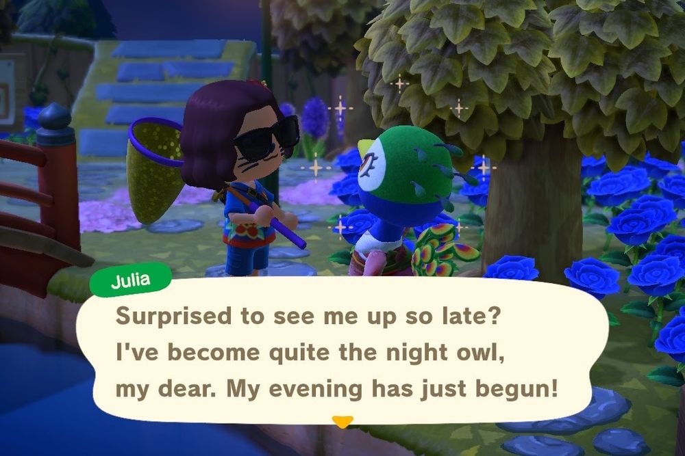 An Animal Crossing New Horizons player wearing Simple sunglasses (at night) and a Bold aloha shirt (navy) and holding a Golden net speaking to Julia, an ostrich (peacock) villager in the night, her head surrounded by sparkle matter, who is saying, "Surprised to see me up so late? I've become quite the night owl, my dear. My evening has just begun!"